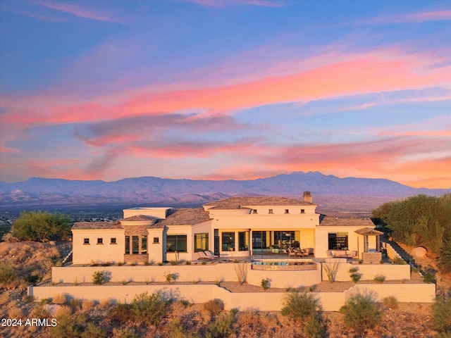 exterior space featuring a mountain view and a patio area