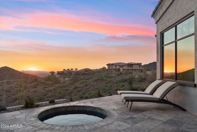 patio terrace at dusk with an in ground hot tub