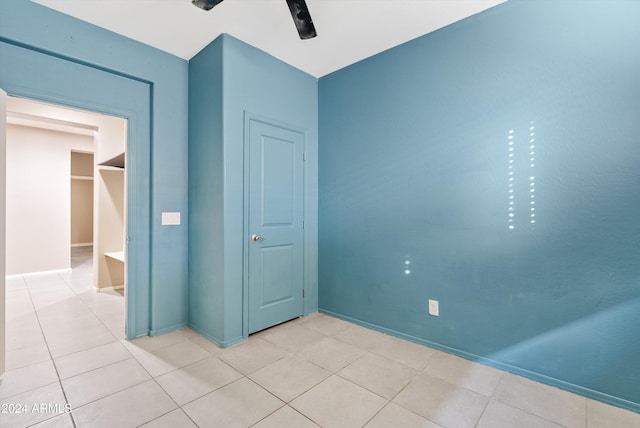 unfurnished bedroom with ceiling fan and light tile patterned floors