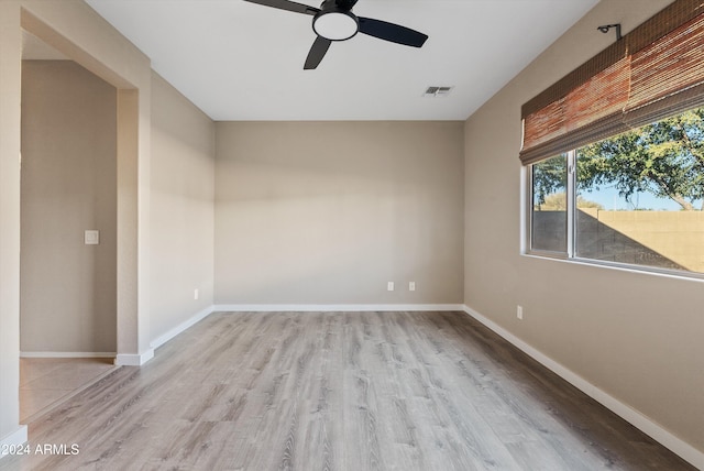 spare room featuring light wood-type flooring and ceiling fan