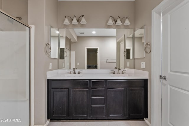 bathroom with tile patterned flooring, vanity, and a shower with shower door