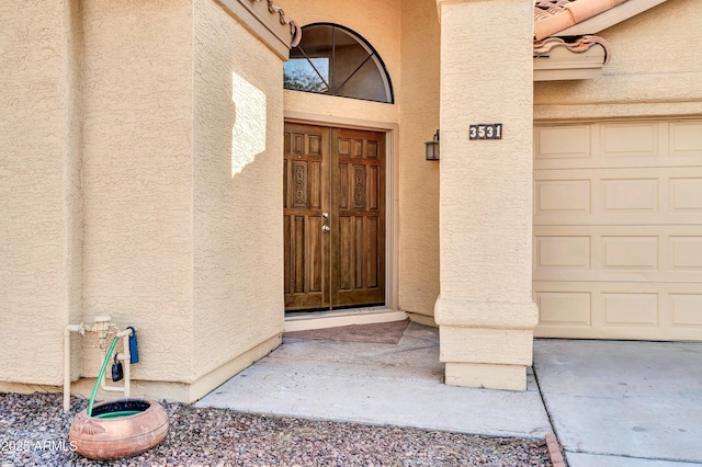 view of exterior entry with a garage