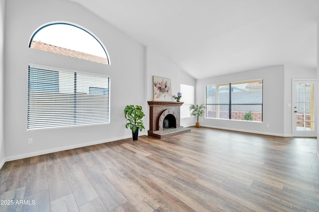 unfurnished living room featuring light wood-type flooring and vaulted ceiling