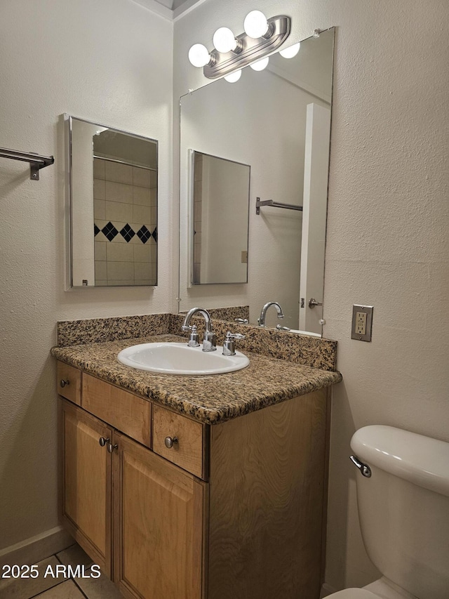 bathroom with toilet and vanity