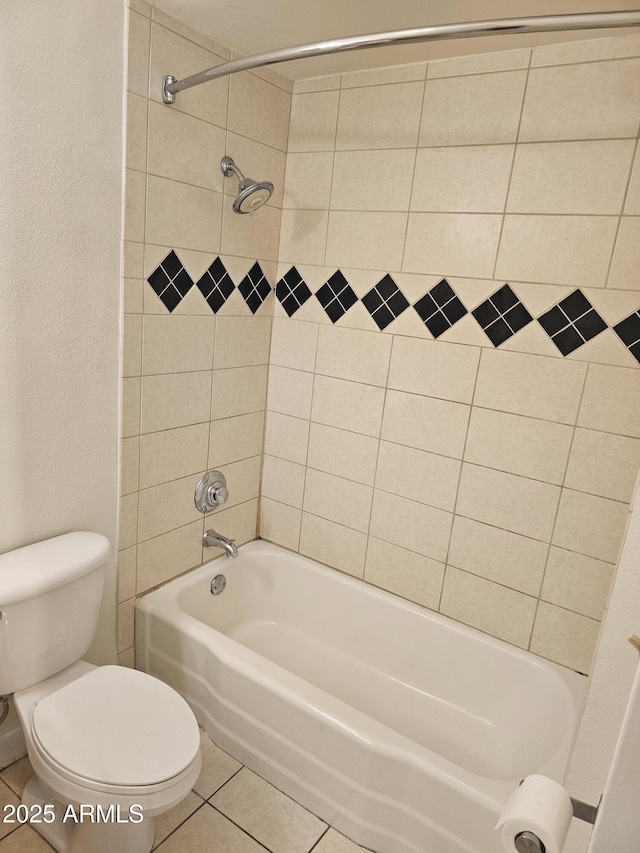 bathroom featuring tile patterned flooring, shower / tub combination, and toilet