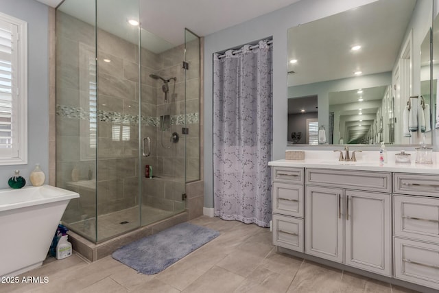 8741 N 185th Ave, Waddell, AZ 85355 - full bathroom featuring a stall shower, vanity, a freestanding bath, and recessed lighting