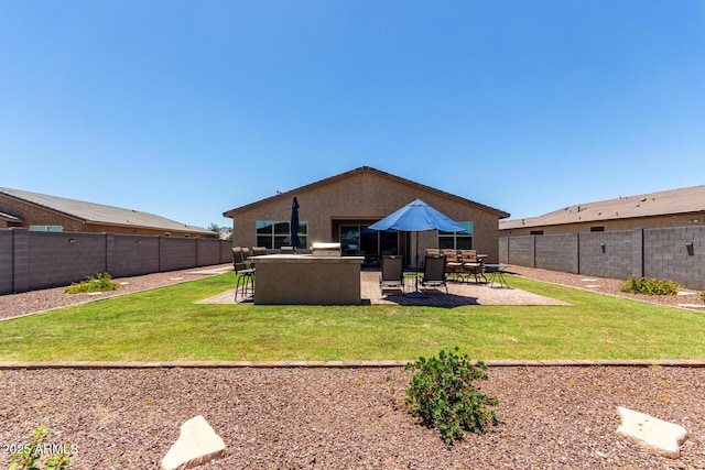 8741 N 185th Ave, Waddell, AZ 85355 - back of house with a fenced backyard, a patio, and stucco siding