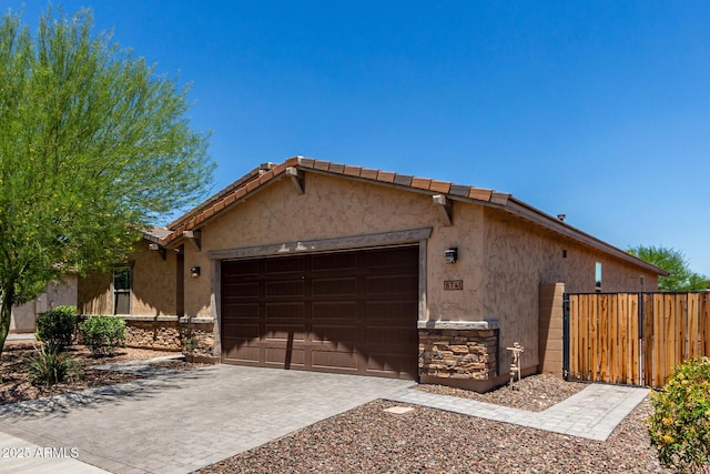 8741 N 185th Ave, Waddell, AZ 85355 - single story home featuring a garage, stone siding, stucco siding, driveway, and a tiled roof