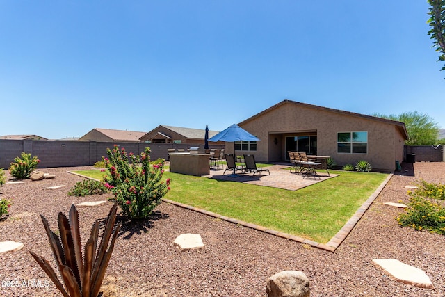 8741 N 185th Ave, Waddell, AZ 85355 - rear view of house featuring a fenced backyard, stucco siding, and a patio