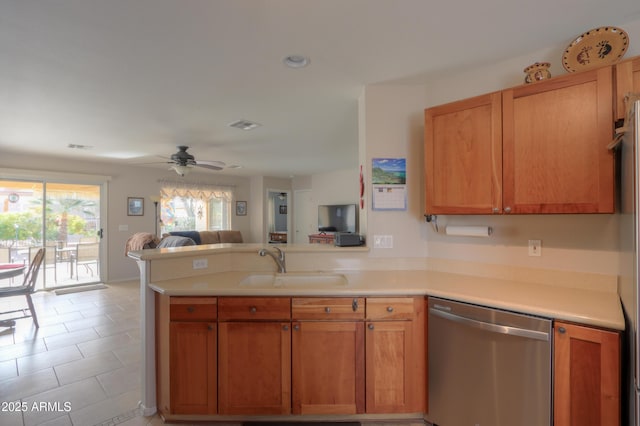 kitchen with dishwasher, sink, light tile patterned floors, ceiling fan, and kitchen peninsula