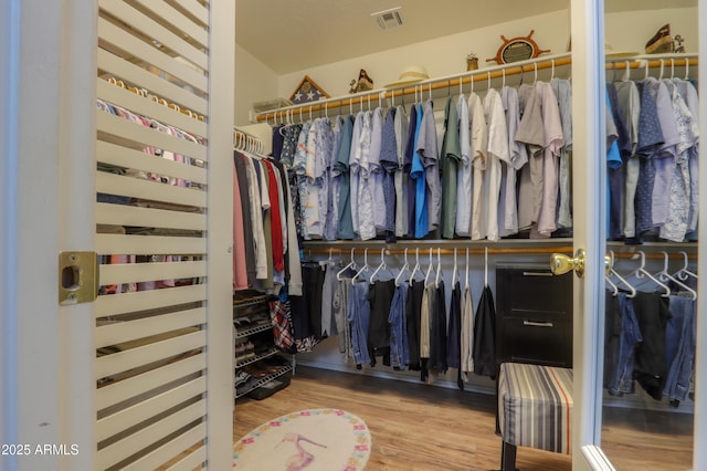 spacious closet featuring hardwood / wood-style floors