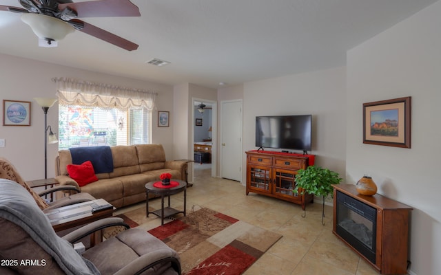 living room with light tile patterned floors and ceiling fan