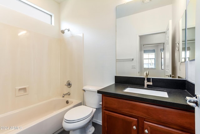 full bathroom with vanity, toilet, washtub / shower combination, and a wealth of natural light