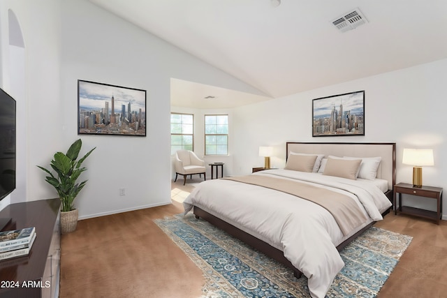 bedroom with carpet and high vaulted ceiling