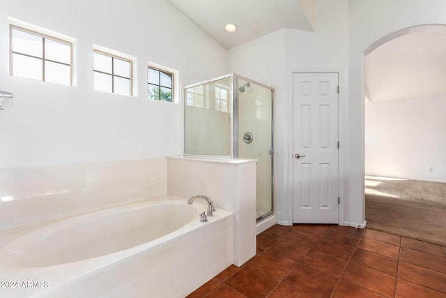 bathroom with separate shower and tub, tile patterned floors, and lofted ceiling