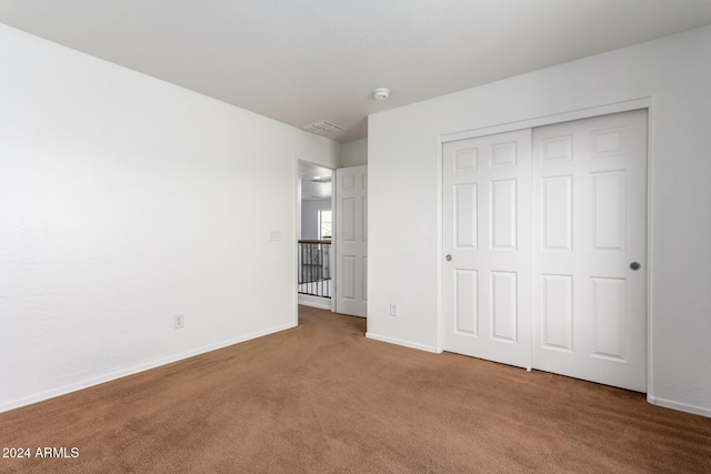 unfurnished bedroom featuring a closet and carpet floors