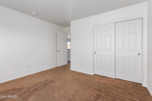 unfurnished bedroom with a closet and carpet