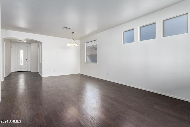 unfurnished room with dark hardwood / wood-style flooring