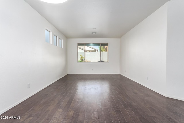 spare room with dark hardwood / wood-style flooring