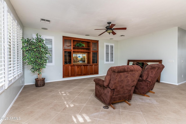 living room featuring ceiling fan and light tile patterned flooring