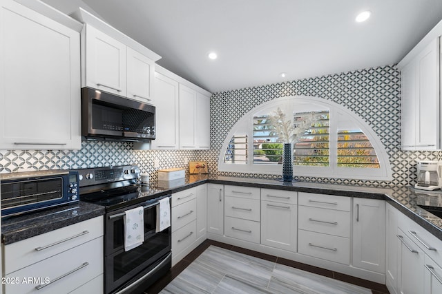 kitchen featuring recessed lighting, stainless steel appliances, white cabinetry, tasteful backsplash, and wallpapered walls