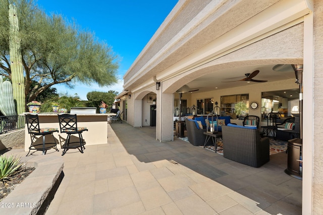 view of patio / terrace featuring a ceiling fan and outdoor dry bar