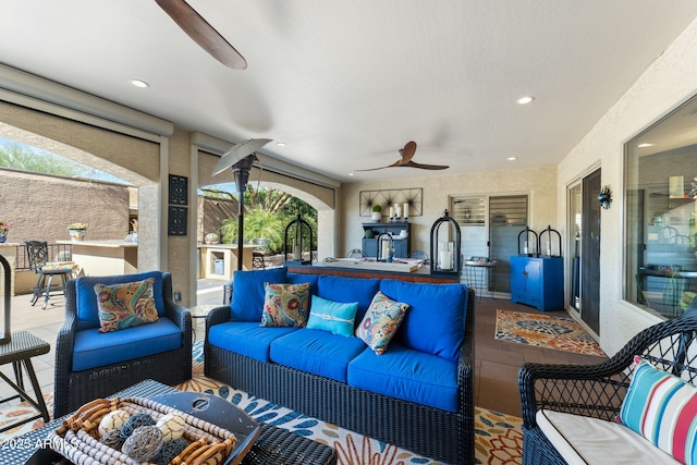 sunroom / solarium featuring ceiling fan