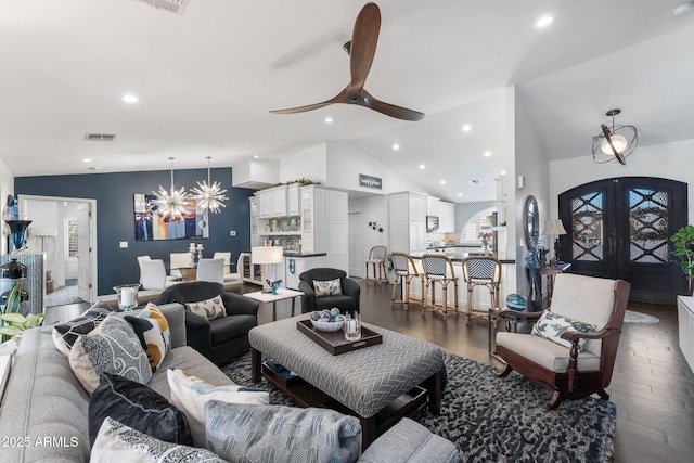 living area with lofted ceiling, french doors, wood finished floors, and visible vents