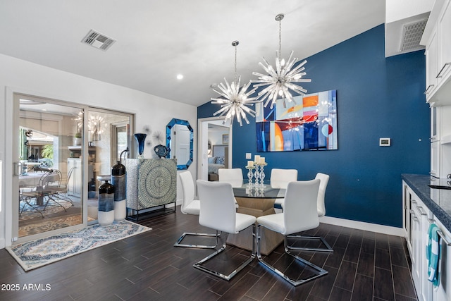 dining space with a notable chandelier, visible vents, and wood tiled floor