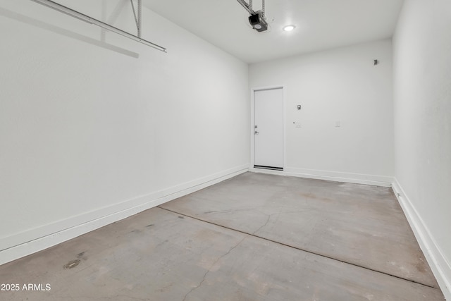 garage with baseboards and a garage door opener