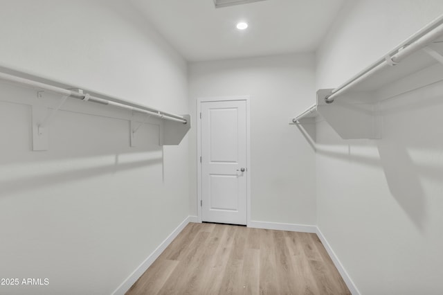 spacious closet featuring light wood-type flooring