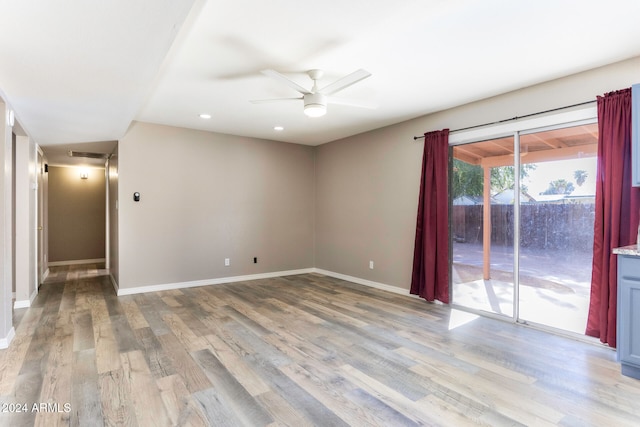 spare room featuring light hardwood / wood-style floors and ceiling fan