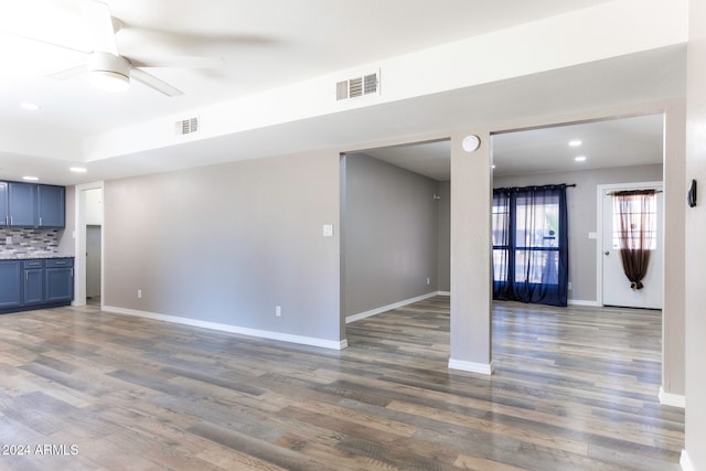 unfurnished living room featuring dark hardwood / wood-style floors and ceiling fan