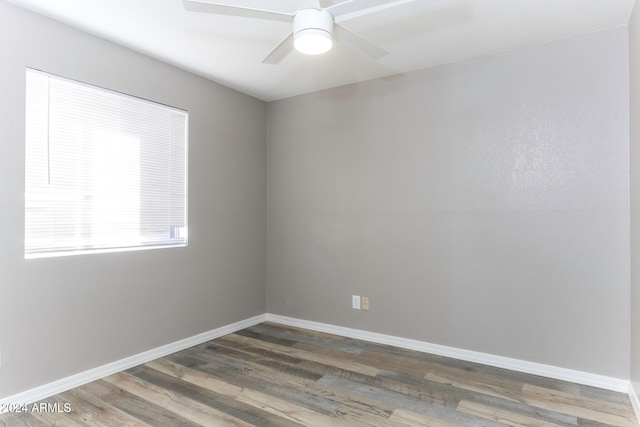 unfurnished room featuring ceiling fan and dark wood-type flooring