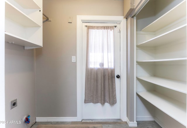 clothes washing area featuring hookup for an electric dryer and hardwood / wood-style floors