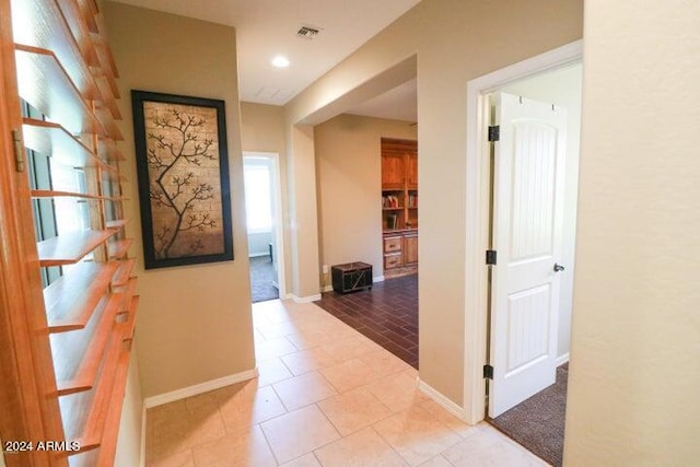 hall with tile flooring