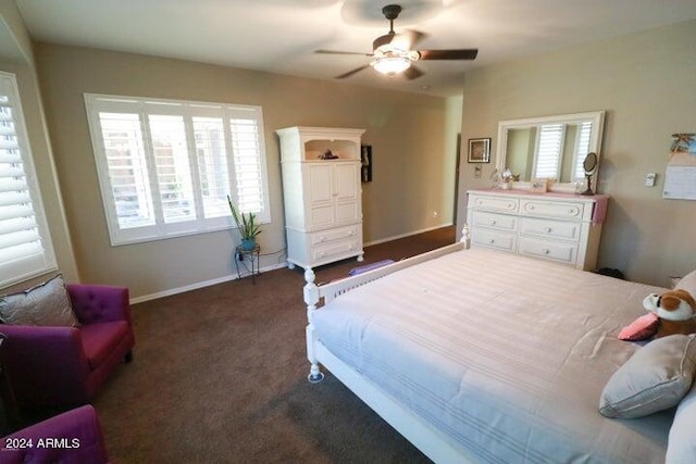 bedroom with ceiling fan and dark carpet