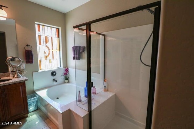 bathroom featuring vanity, separate shower and tub, and tile flooring