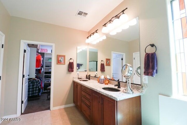 bathroom featuring a wealth of natural light, vanity, and tile flooring