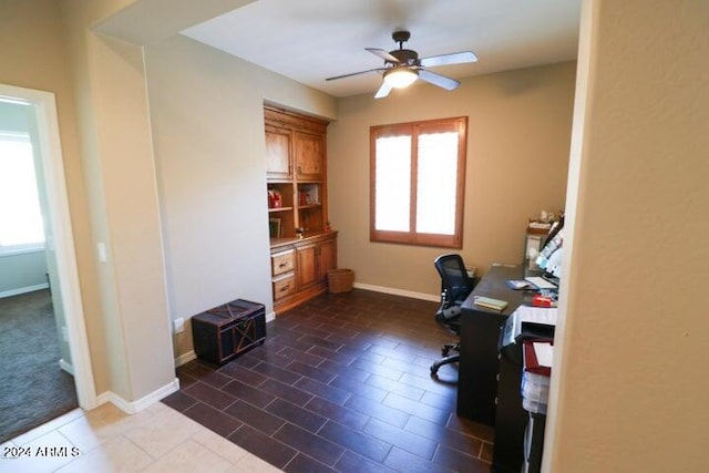 office area with ceiling fan, a healthy amount of sunlight, and tile floors