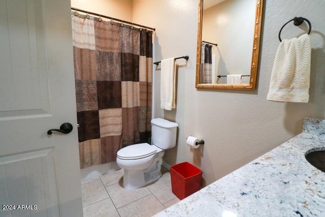 bathroom featuring vanity, tile floors, and toilet