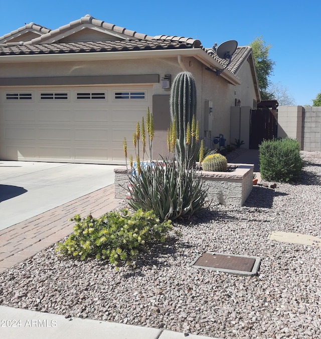 view of side of home featuring a garage