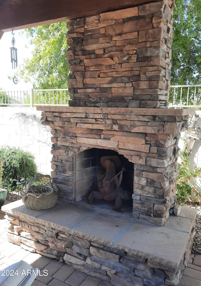 exterior details with an outdoor stone fireplace