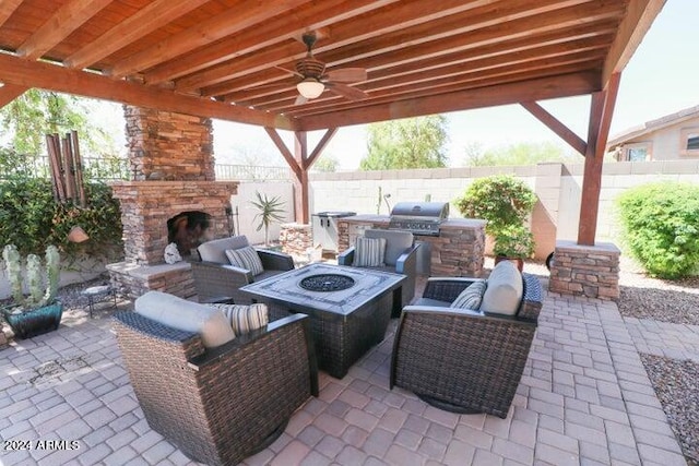 view of patio / terrace with area for grilling, an outdoor living space with a fireplace, and ceiling fan