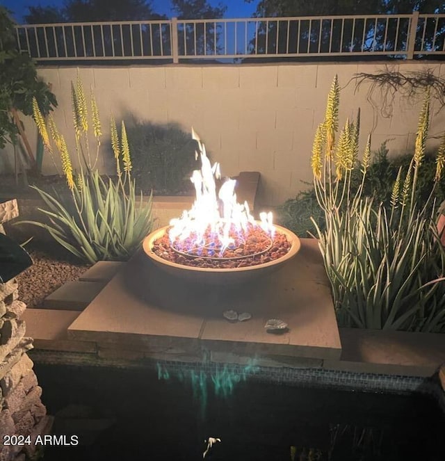 details with a fire pit and a chandelier