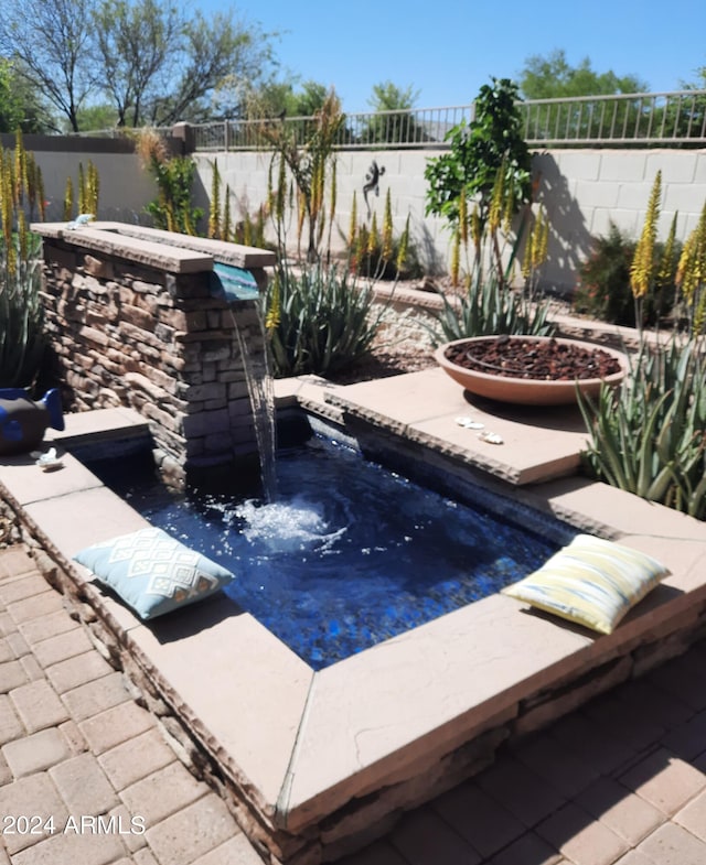 view of pool with a jacuzzi