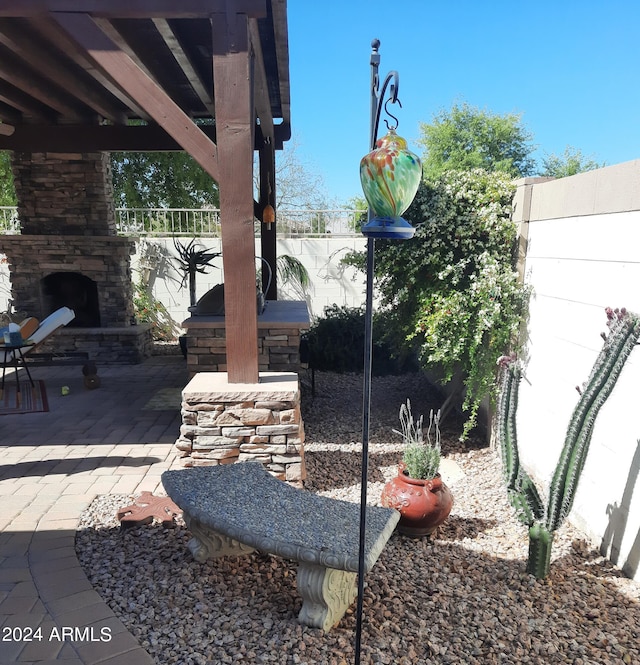 exterior space featuring a patio and an outdoor stone fireplace