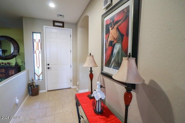 foyer featuring plenty of natural light and light tile floors