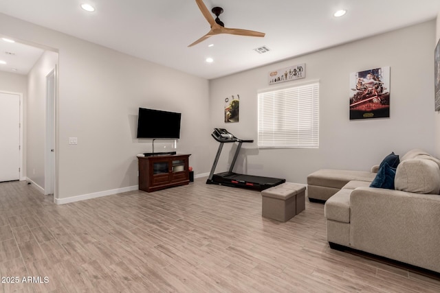 living room featuring light hardwood / wood-style floors and ceiling fan