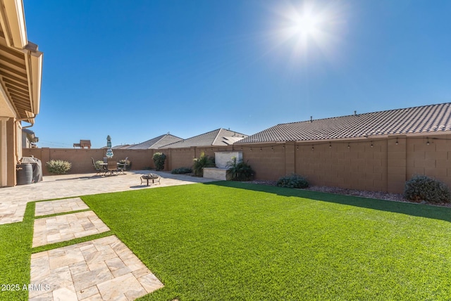 view of yard featuring a patio and an outdoor fire pit